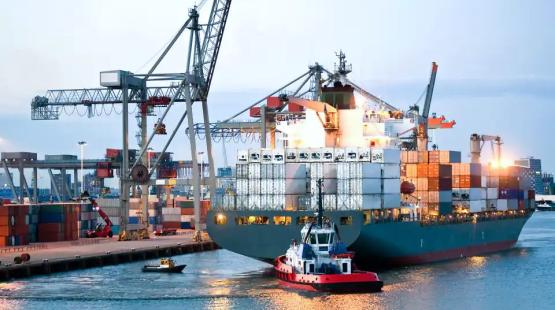 Container vessel at berth with a tug