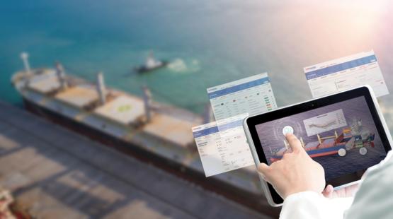 (c)TotalEnergies Shipping operator consulting a dashboard on an Ipad - bulk vessel in background