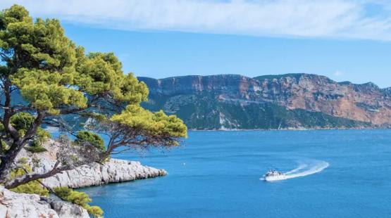 (c)TotalEnergies, AdobeStock Mediterranean Sea coast view with a small ship
