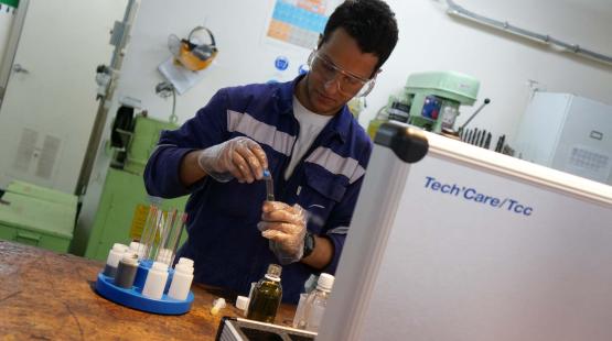A technician wearing PPE during an onboard lubricant analysis operation A technician wearing PPE during an onboard lubricant analysis operation